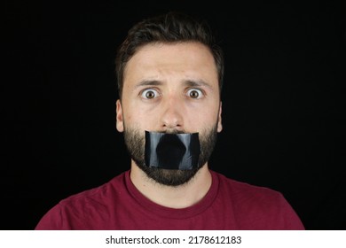 Young Caucasian Man Can't Speak, Black Tape On The Mouth. 