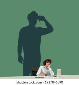 Young Caucasian Man Dreaming About Future In Big Sailing On An Open Sea During His Work In Office. Shadow, Silhouette Of Sailor With Binocular On The Wall. Inspiration, Aspiration. Copyspace.