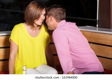 Young Caucasian Man Flirting With A Woman While Hanging Out At A Bar At Night