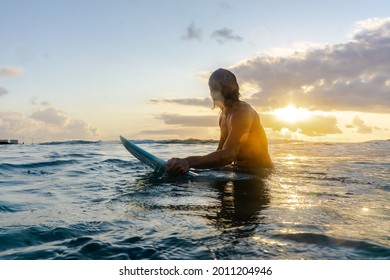 Young caucasian man get up early to  doing surf at sunrise - Powered by Shutterstock