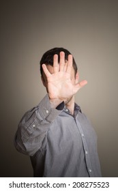 Young Caucasian Man Hiding His Face With Hand