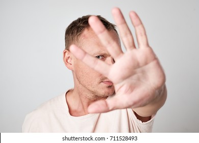 Young Caucasian Man Hiding His Face With Hand