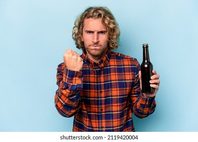 Young Caucasian Man Holding Beer Isolated On White Background Showing Fist To Camera, Aggressive Facial Expression.