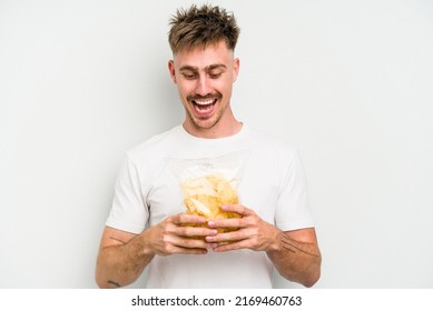 Young caucasian man holding crisps isolated on white background