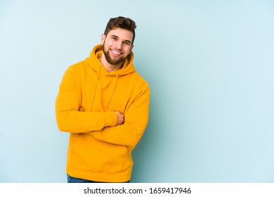 Young caucasian man isolated on blue background laughing and having fun. - Powered by Shutterstock