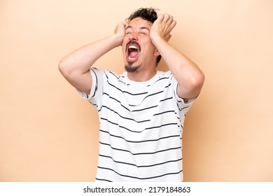 Young Caucasian Man Isolated On Beige Background Stressed Overwhelmed