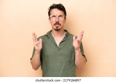 Young Caucasian Man Isolated On Beige Background Stressed Overwhelmed