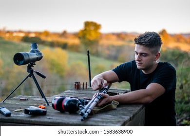 Young Caucasian Man Loading A Rifle At Outdoor Firing Range Or Shooting Range In Kentucky