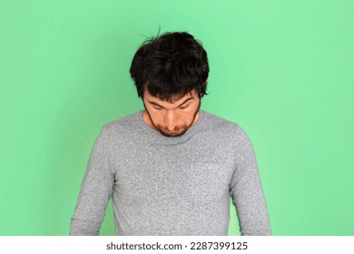 Young caucasian man looking down. Green screen background. Technologies concept. Humor. Business. Networking concept. Social networks. - Powered by Shutterstock