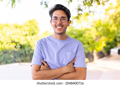 Young caucasian man at outdoors in a park keeping the arms crossed in frontal position - Shutterstock ID 2048400716