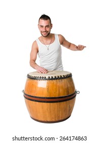 Young Caucasian Man Playing Drums On Old African Drums