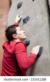 Young Caucasian Man Rock Climbing Indoors