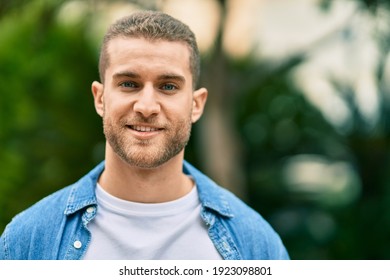 Young Caucasian Man Smiling Happy Standing At The Park.