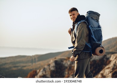 Young caucasian man traveler with big backpack hiking in the mountains - Powered by Shutterstock