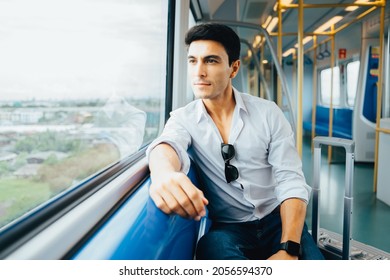 Young Caucasian man traveler sitting inside empty subway or sky train car.   - Powered by Shutterstock