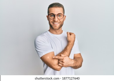 Young caucasian man wearing band aid for vaccine injection smiling with a happy and cool smile on face. showing teeth.  - Powered by Shutterstock