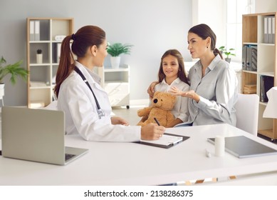 Young Caucasian Mom And Teen Daughter Child Visit Pediatrician In Hospital Or Clinic. Caring Mother And Girl Kid Have Consultation With Female Doctor Or GP. Childcare, Healthcare, Medicine Concept.