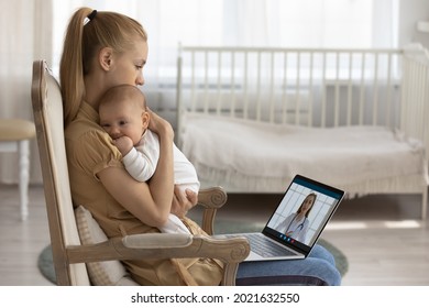 Young Caucasian Mother Sit In Chair Hold Baby Infant In Arms Speak On Video Call With Pediatrician. Loving Mom Caress Lull Small Newborn Son Daughter Have Webcam Digital Talk On Computer With Doctor.