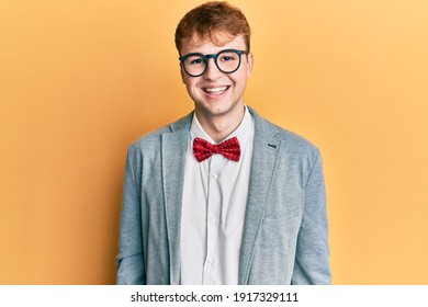 Young caucasian nerd man wearing glasses wearing hipster elegant look with bowtie looking positive and happy standing and smiling with a confident smile showing teeth 
