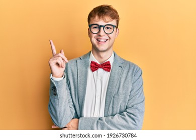 Young Caucasian Nerd Man Wearing Glasses Wearing Hipster Elegant Look With Bowtie Smiling Happy Pointing With Hand And Finger To The Side 