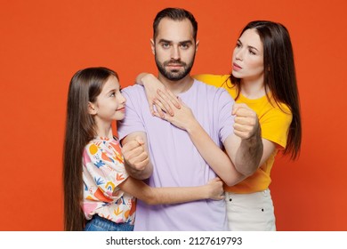 Young Caucasian Parents Mom Dad With Child Kid Daughter Teen Girl In Basic T-shirts Father Hold Hands Like Driving Car Hugging Like Safety Belt Isolated On Yellow Background Studio Portrait Family Day