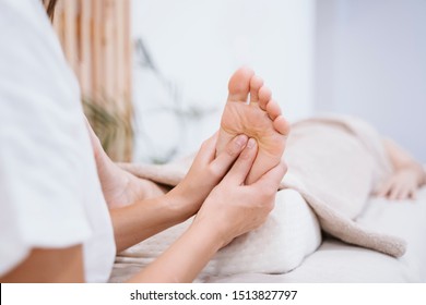 young caucasian physiotherapist Woman giving a feet massage to female patient in clinic. Physiotherapy and body care concept - Shutterstock ID 1513827797