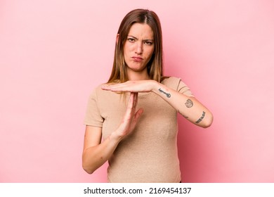 Young caucasian pregnant woman isolated on white background showing a timeout gesture. - Powered by Shutterstock