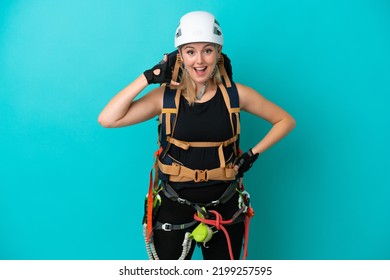 Young Caucasian Rock Climber Woman Isolated On Blue Background Making Phone Gesture. Call Me Back Sign