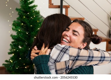 Young Caucasian Sisters Hug Each Other On Christmas Day. Happiness. Affection. Love.