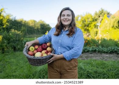 Young Caucasian smile woman farmer worker picking fresh ripe apples in orchard garden during autumn harvest. Hands, apple in basket. Harvesting time.  - Powered by Shutterstock