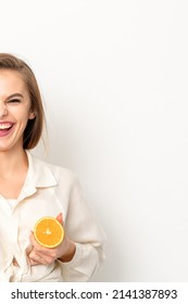 Young Caucasian Smiling Woman Holding Slices Orange Over Isolated White Background, Breast Health Concept.