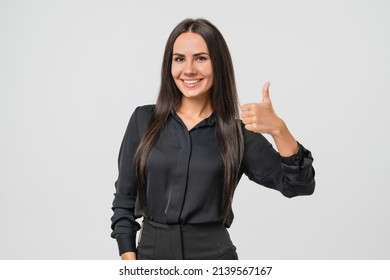 Young caucasian successful businesswoman in black formal clothes showing thumb up isolated in white background. Occupation, ceo management. Well done! - Powered by Shutterstock