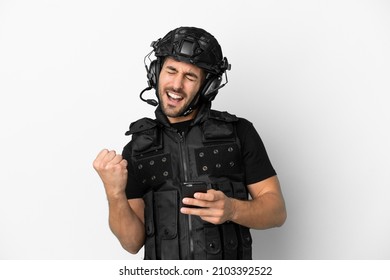 Young Caucasian Swat Isolated On White Background With Phone In Victory Position