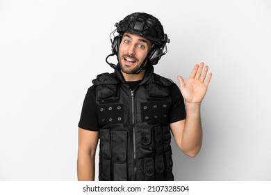 Young Caucasian Swat Isolated On White Background Saluting With Hand With Happy Expression