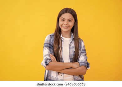 young caucasian teen girl look at the camera isolated on yellow. teen caucasian girl wear checkered shirt in studio. caucasian teen girl in casual style. smiling teen caucasian girl on background - Powered by Shutterstock