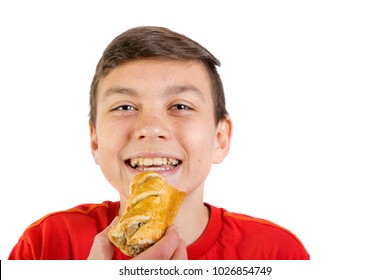 Young Caucasian Teenage Boy Eating A Sausage Roll