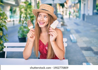 Young Caucasian Tourist Girl Smiling Happy Eating Ice Cream Sitting At Coffe Shop Terrace.