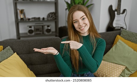 A young caucasian woman with blonde hair points to her open palm, smiling in her cozy, modern living room. - Powered by Shutterstock