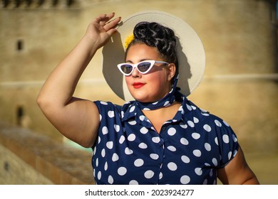 Young Caucasian Woman In Blue Vintage Pinup Dress 50s, White Hat And White Sunglasses