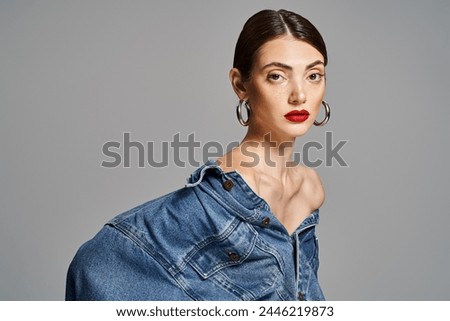 Similar – Image, Stock Photo Portrait of young bold African American female in long zipper coat confidently looking at camera standing on orange background