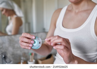 Young Caucasian Woman Checking Teeth After Flossing