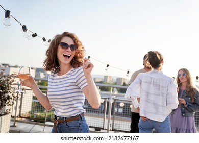 Young caucasian woman dancing at the rooftop party - Powered by Shutterstock