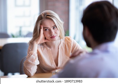 Young Caucasian Woman Disinterested In Blind Date, Feeling Bored With Conversation At City Cafe. Millennial Couple Having Relationship Problems, Going Through Breakup Or Divorce