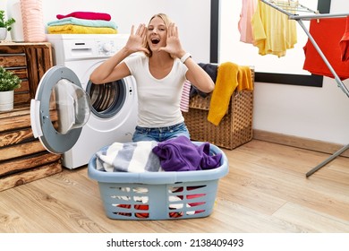 Young Caucasian Woman Doing Laundry With Clothes In The Basket Smiling Cheerful Playing Peek A Boo With Hands Showing Face. Surprised And Exited 