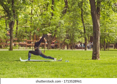 Young Caucasian Woman Doing Yoga In The Park.