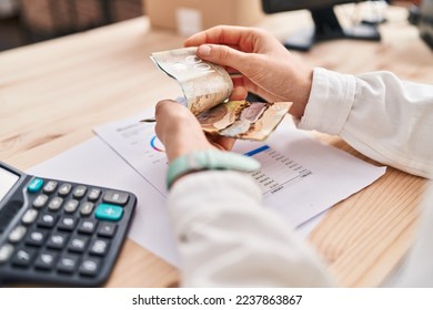 Young caucasian woman ecommerce business worker counting canada dollars at office