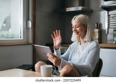young caucasian woman having video call sits in her home - Shutterstock ID 2207225499