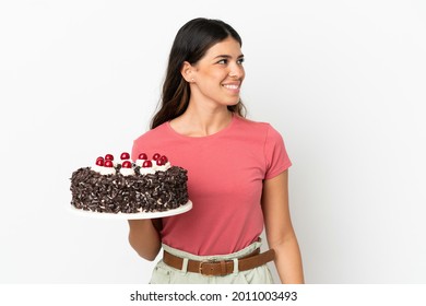 Young Caucasian Woman Holding Birthday Cake Isolated On White Background Looking Side