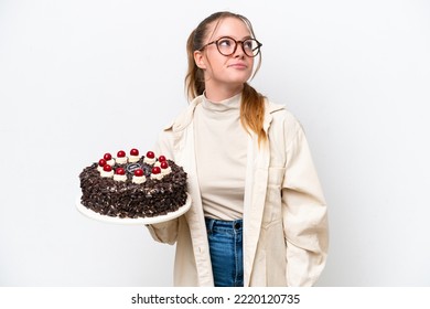 Young Caucasian Woman Holding A Birthday Cake Isolated On White Background And Looking Up