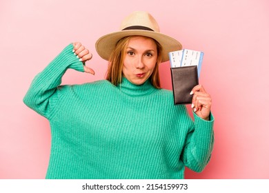 Young Caucasian Woman Holding A Passport Isolated On Pink Background Feels Proud And Self Confident, Example To Follow.